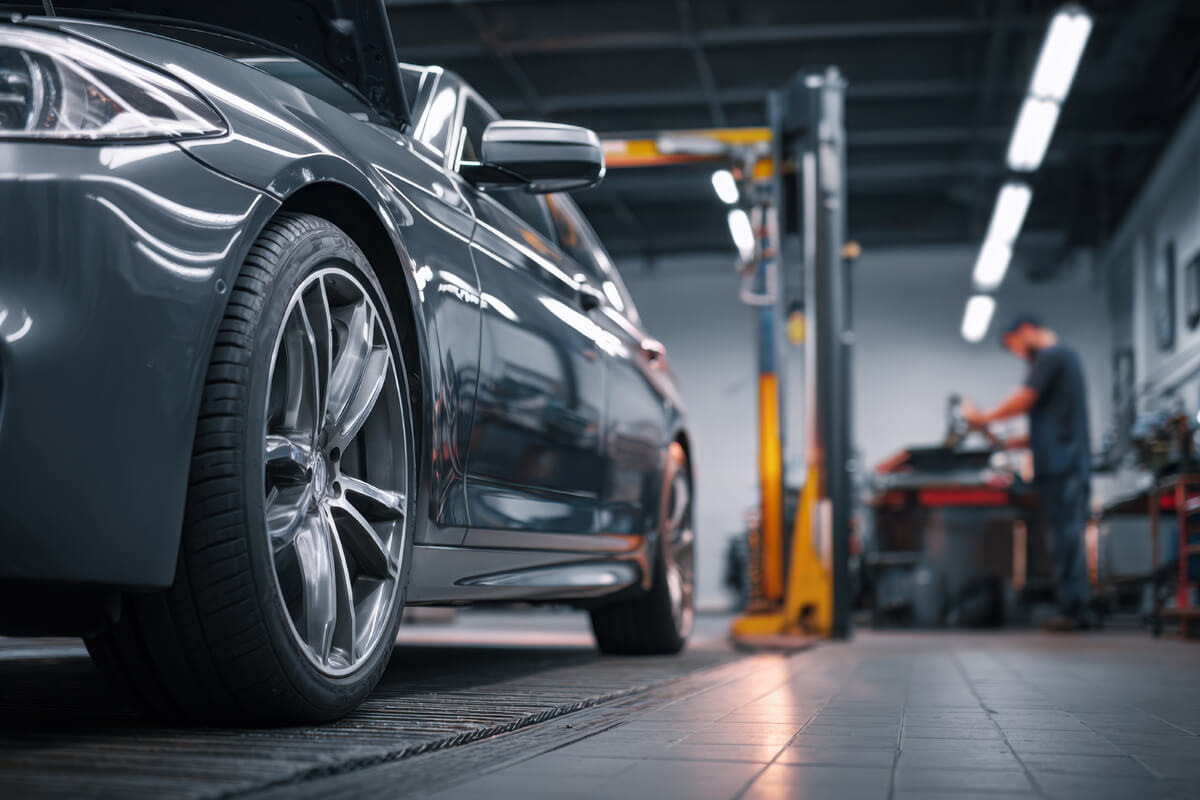 Werkstatt mit Auto und Mitarbeiter